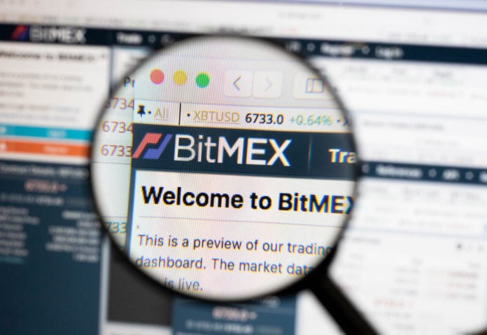 BitMEX logo on a computer screen with a magnifying glass.