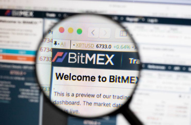 BitMEX logo on a computer screen with a magnifying glass.