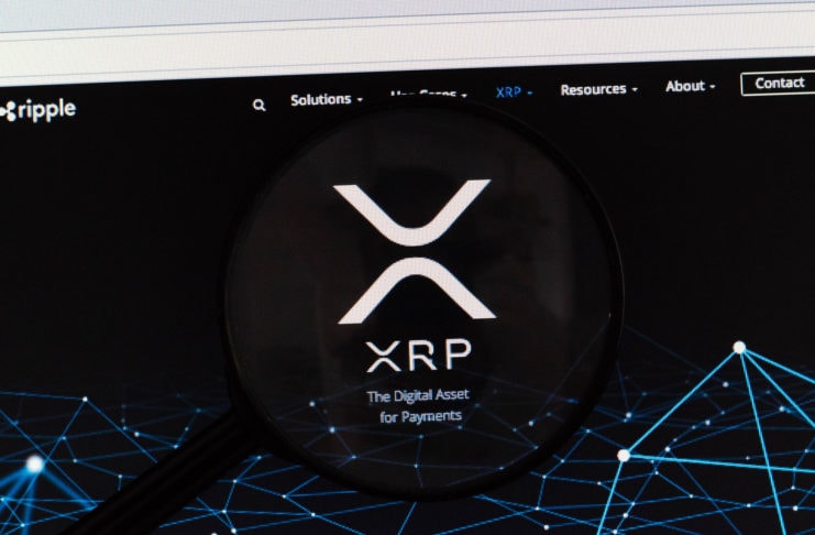 Ripple Logo under magnifying glass, with a dark background.