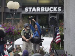 Photographer and a soldier in front of a Starbucks.