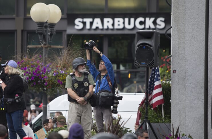 Photographer and a soldier in front of a Starbucks.